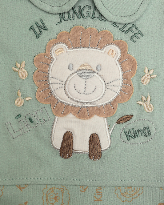 Close-up of lion king embroidery patch with In Jungle Life text and paw prints on mint green baby top