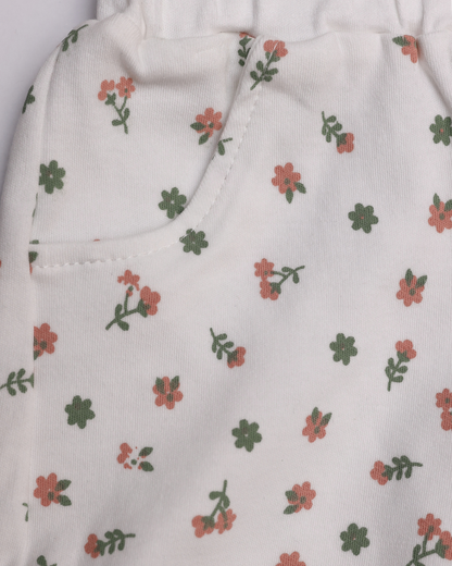 Close-up of white floral shorts with pink and green flower print and side pocket