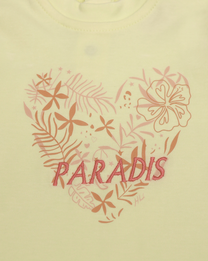 Close-up of Paradis tropical floral heart embroidery with hibiscus and palm leaves on yellow baby top